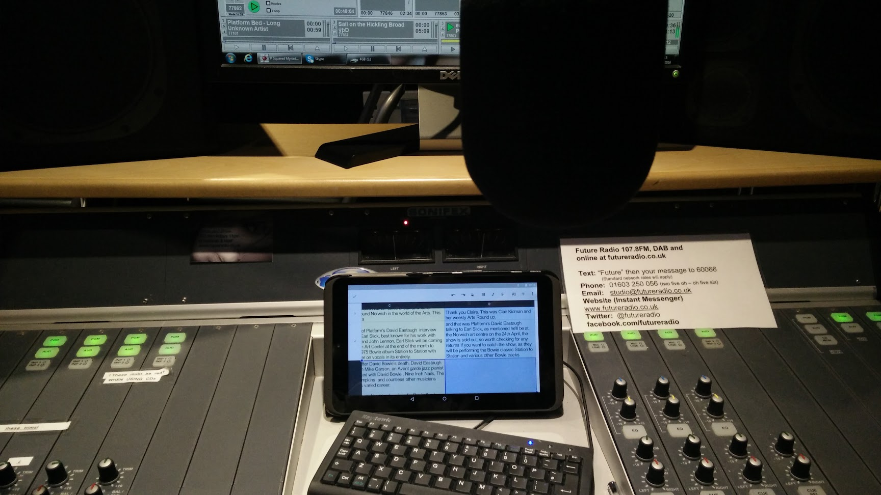 Radio studio mixing desk with microphone, tablet and keyboard